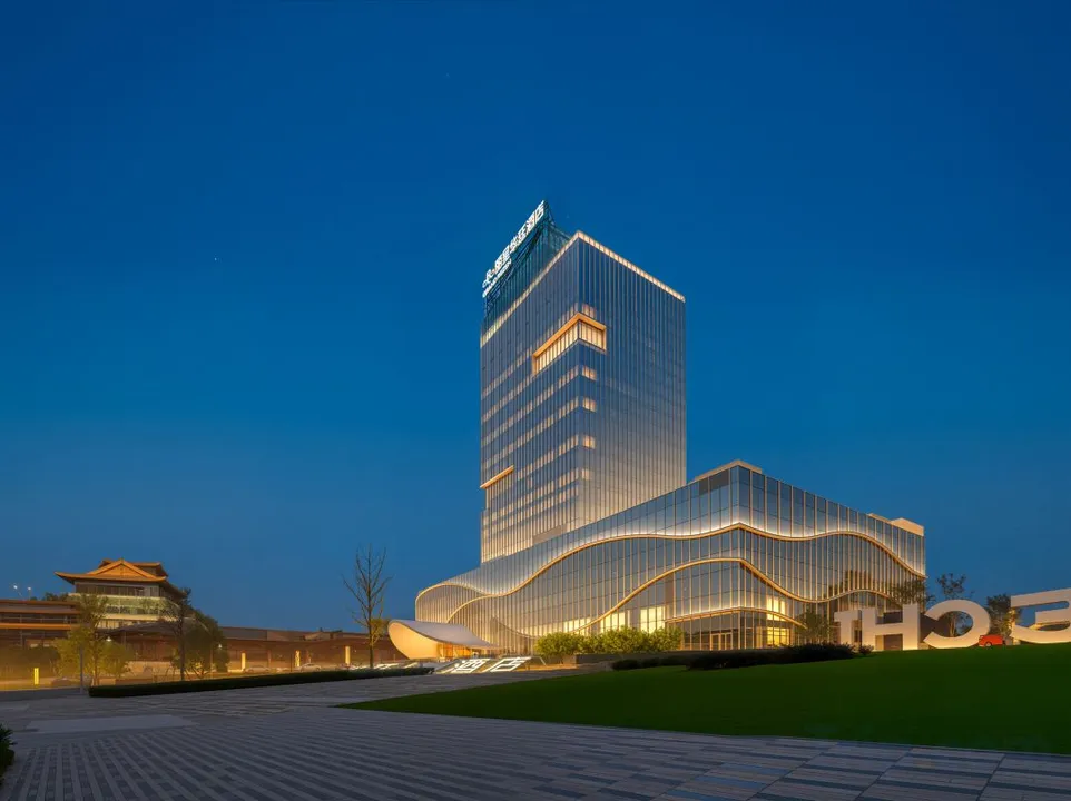 Grand Rezen illuminated against a deep blue night sky